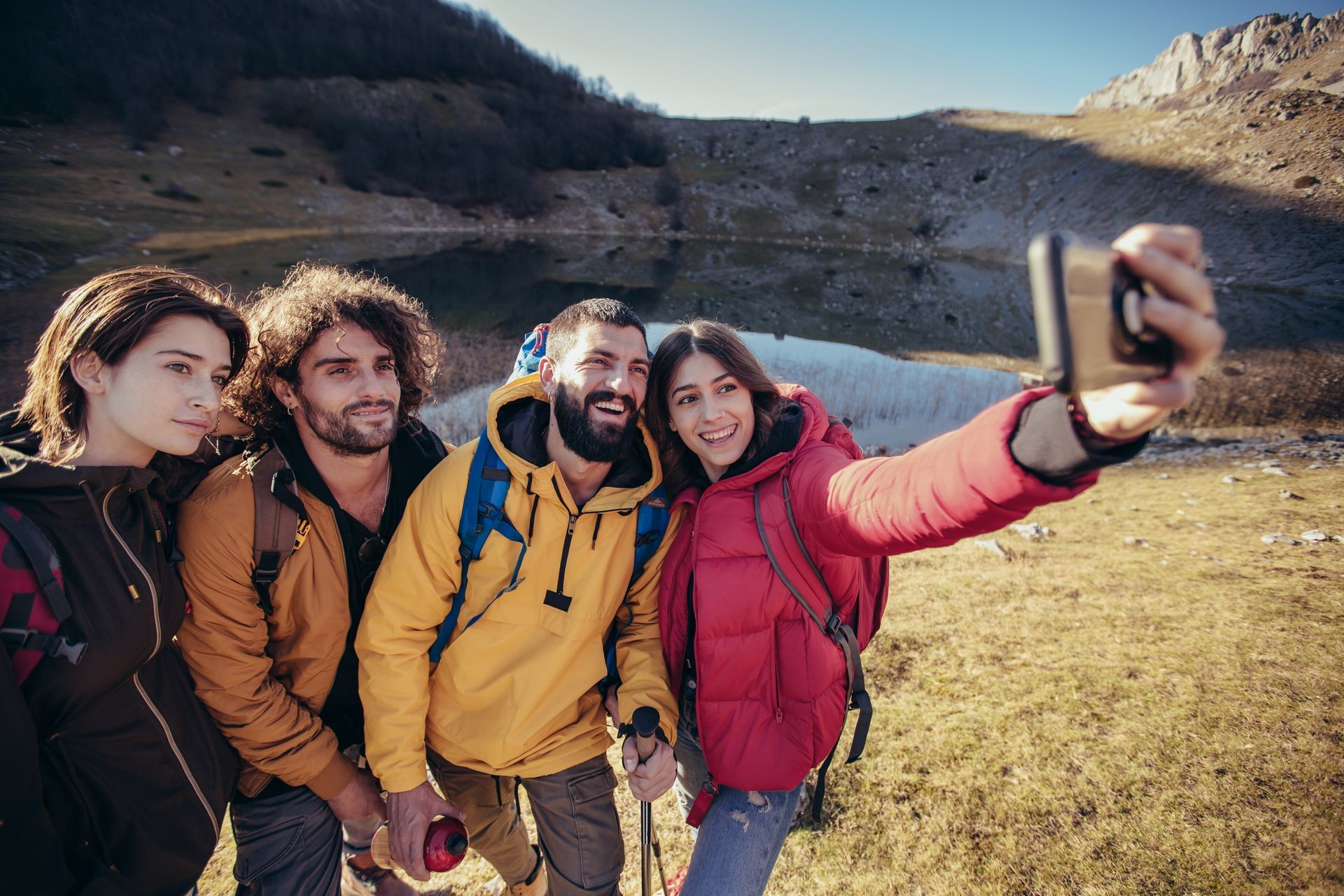 Group of hikers on a mountain at autumn day make selfie photo Group of hikers on a mountain at autumn day make selfie photo
